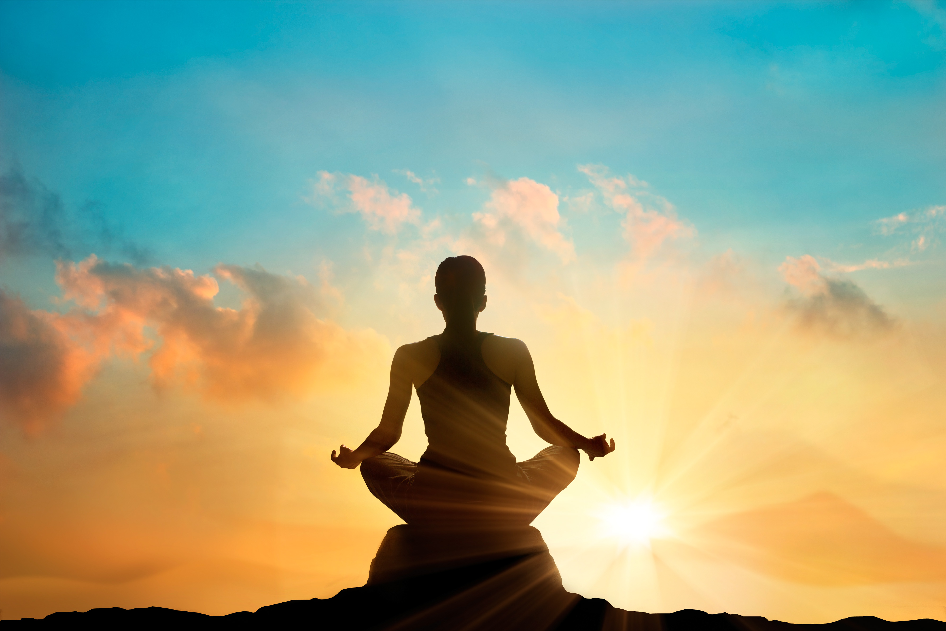 women meditating pastel on high mountain in sunset background